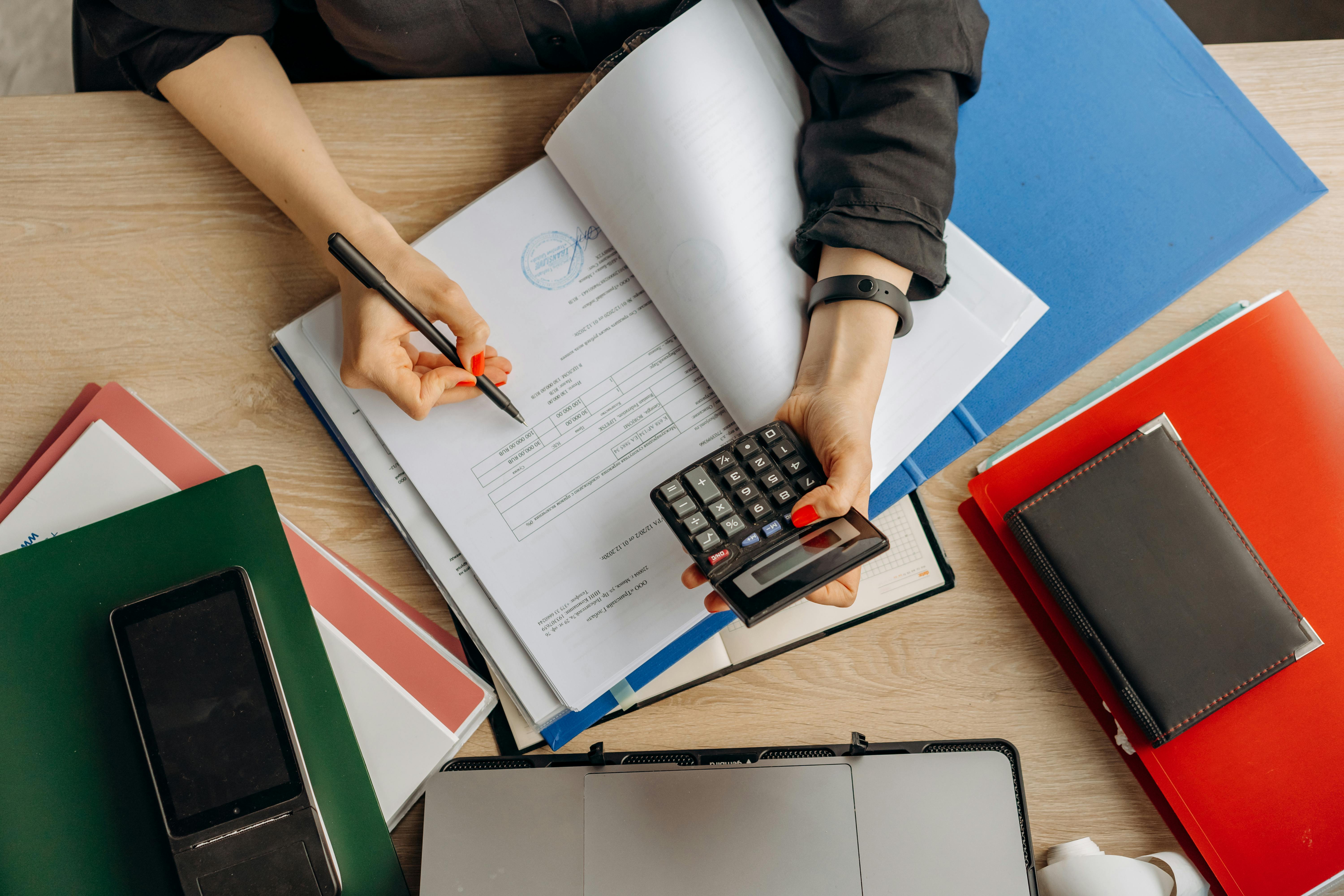 Accounting person with note book, calculator and pen Directors' Loan Accounts SALee ACcountancy Ltd